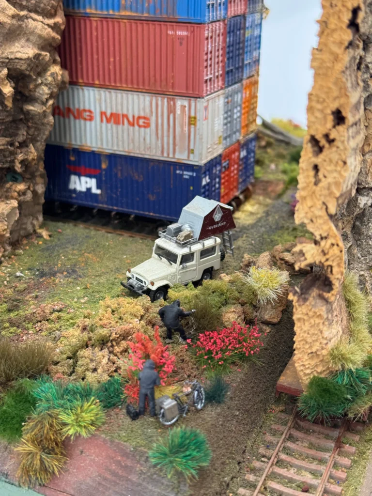 Kim Adams Stash Exhibition, zoomed into the camping car near the rails. It looked like these super mini people were looking for something lost.